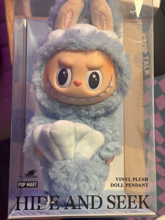 The "Pop Mart Hide and Seek" refers to a specific series of collectible vinyl plush doll pendants featuring the character Labubu, designed by Kasing Lung, created by Pop Mart exclusive, Singapore-release